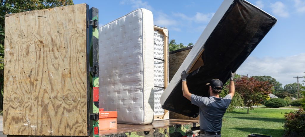 Professional mattress removal crew loading old mattress into truck in Canonsburg PA.