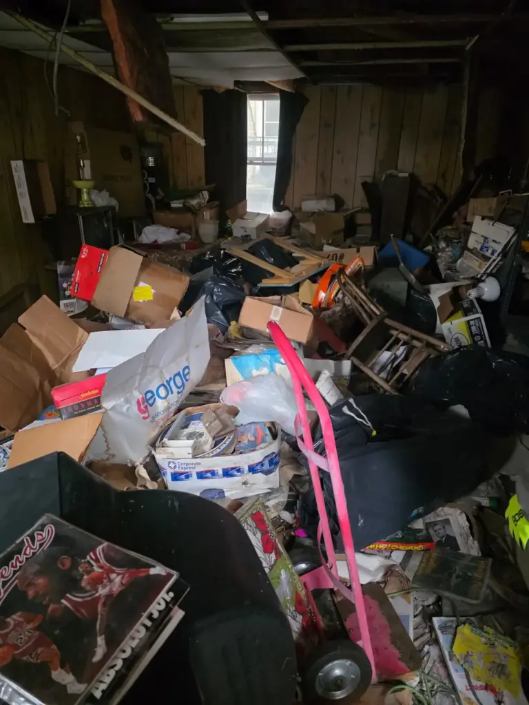 Before photo of a cluttered room at a hoarding cleanout job by Iron Bear & Co.