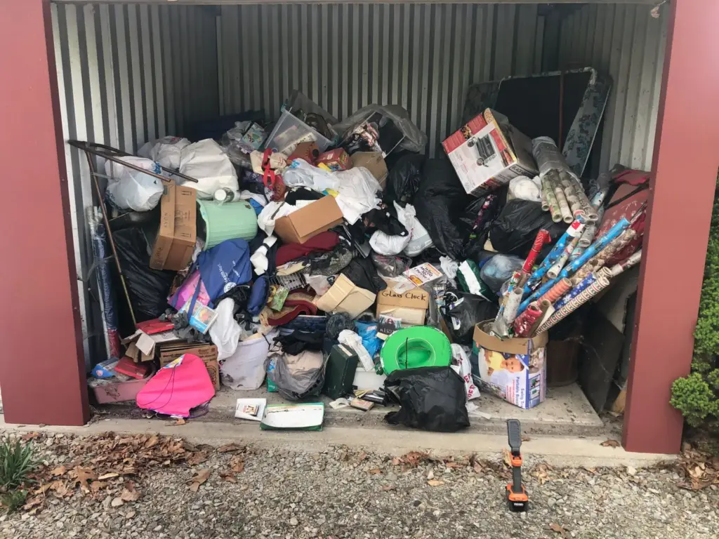 Before photo of a packed storage unit cleanout job by Iron Bear & Co.