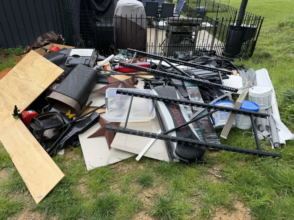 Before photo of yard debris and scrap waiting for removal by Iron Bear & Co.