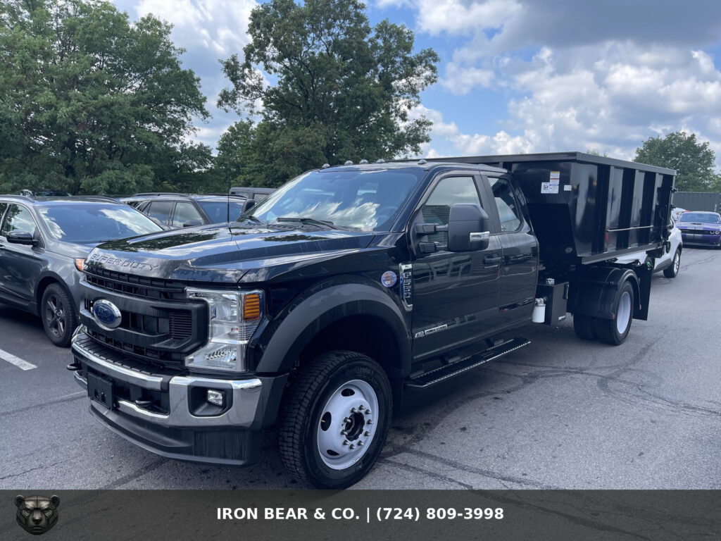 Black Iron Bear & Co. Ford Super Duty truck with a dump body, used to haul away demolition debris